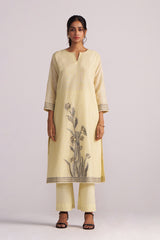 Woman wearing a Butter Yellow Chanderi Woven Kurta Set on a light gray background