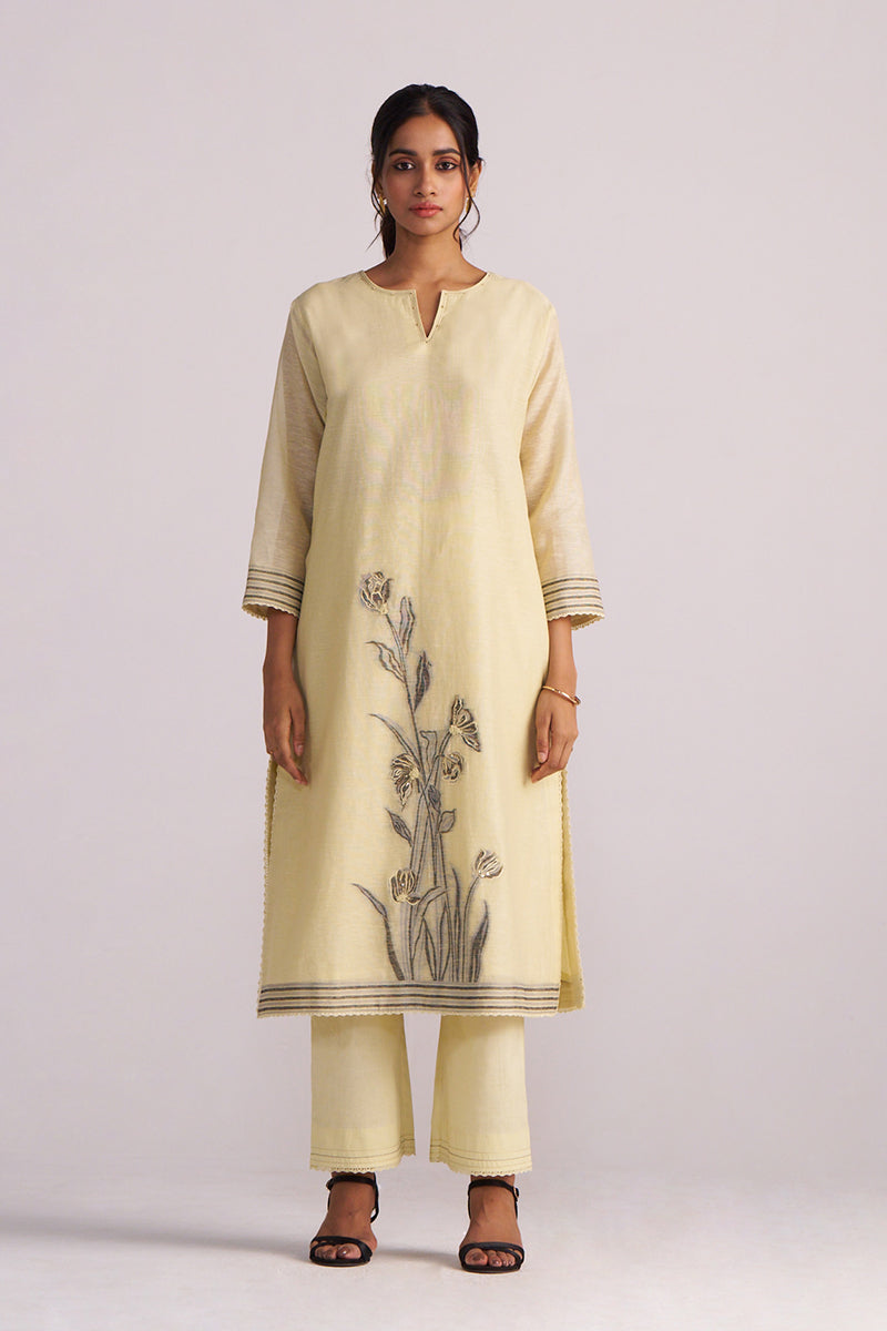 Woman wearing a Butter Yellow Chanderi Woven Kurta Set on a light gray background