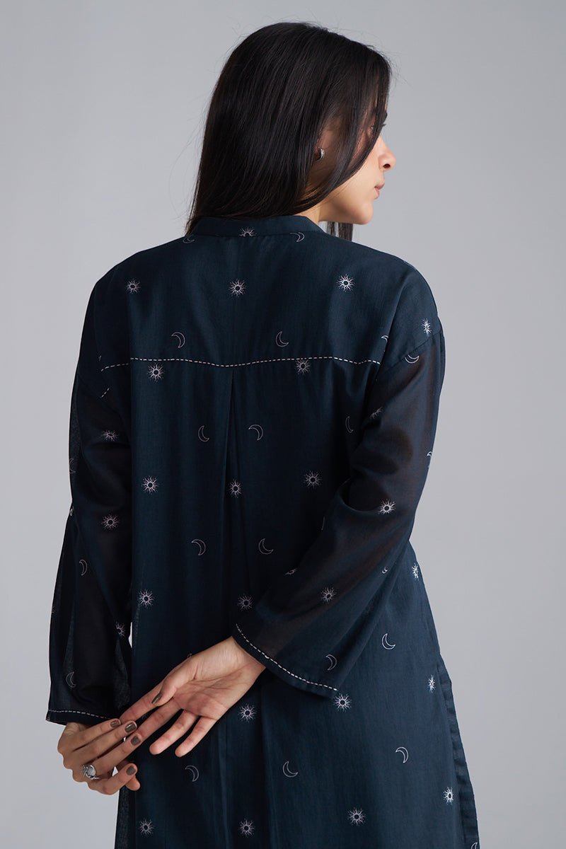 Woman wearing a dark blue embroidered dress against a gray background | Black & White Mul Mul Co-ord Set for Women | Ganga Fashions