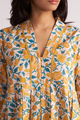 Woman wearing a Beige and Mustard Cotton Print Co-ord Set on a white background