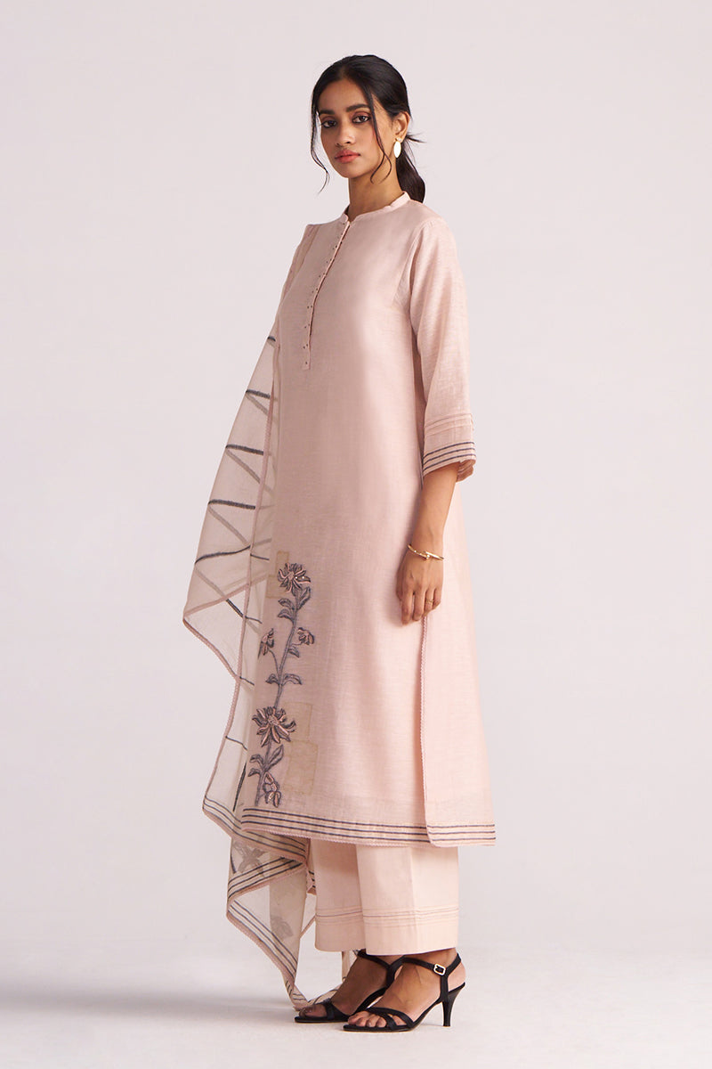 Woman wearing a Sepia Rose Woven Chanderi Kurta Set outfit with floral embroidery on a white background