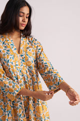 Woman wearing a Beige and Mustard Cotton Print Co-ord Set on a white background