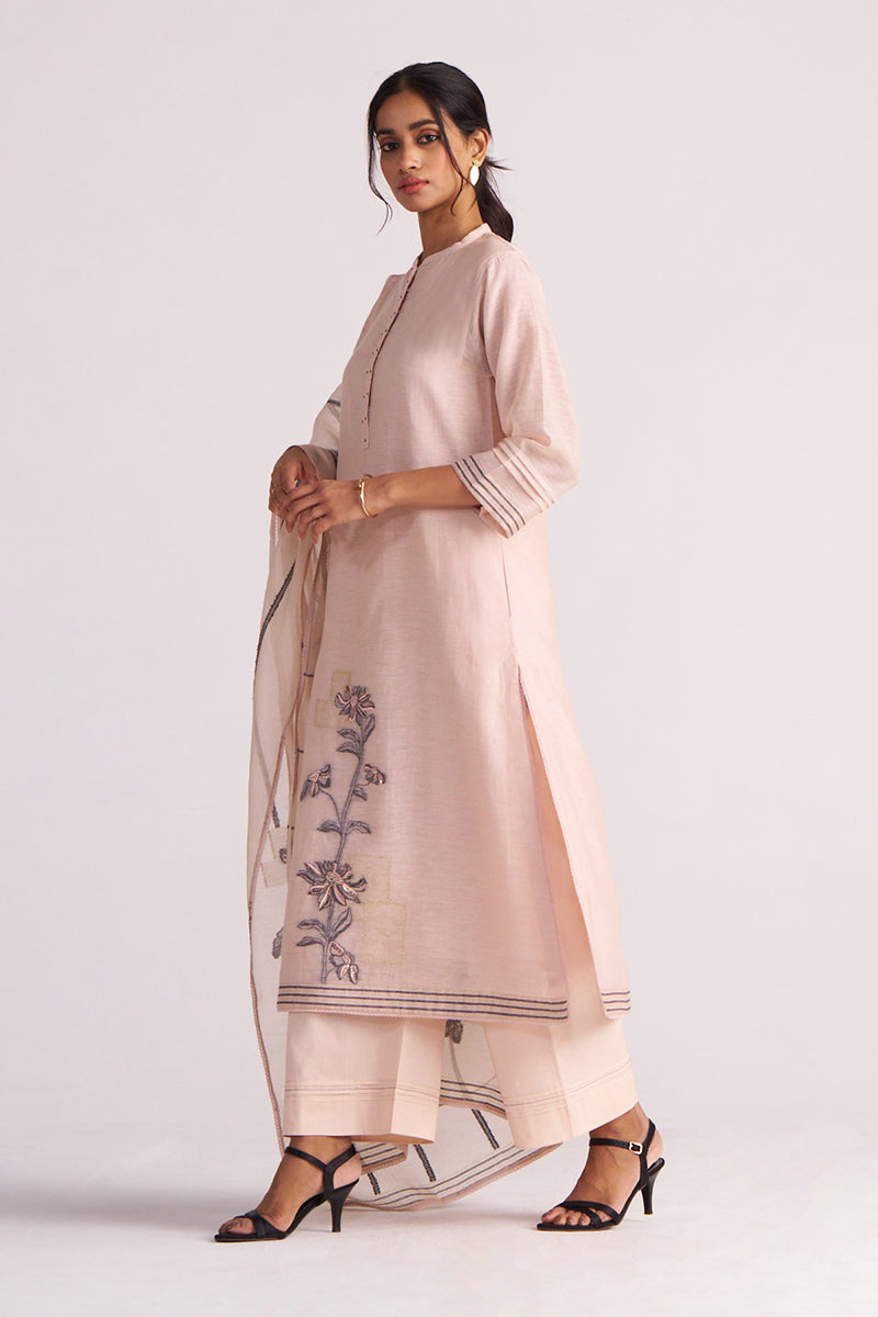 Woman wearing a Sepia Rose Woven Chanderi Kurta Set outfit with floral embroidery on a white background