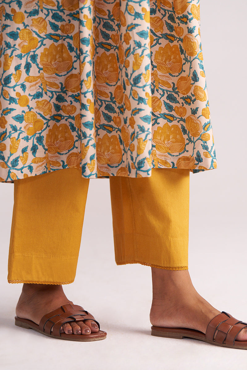 Close-up of a person wearing Beige and Mustard Cotton Print Co-ord Set with a white background