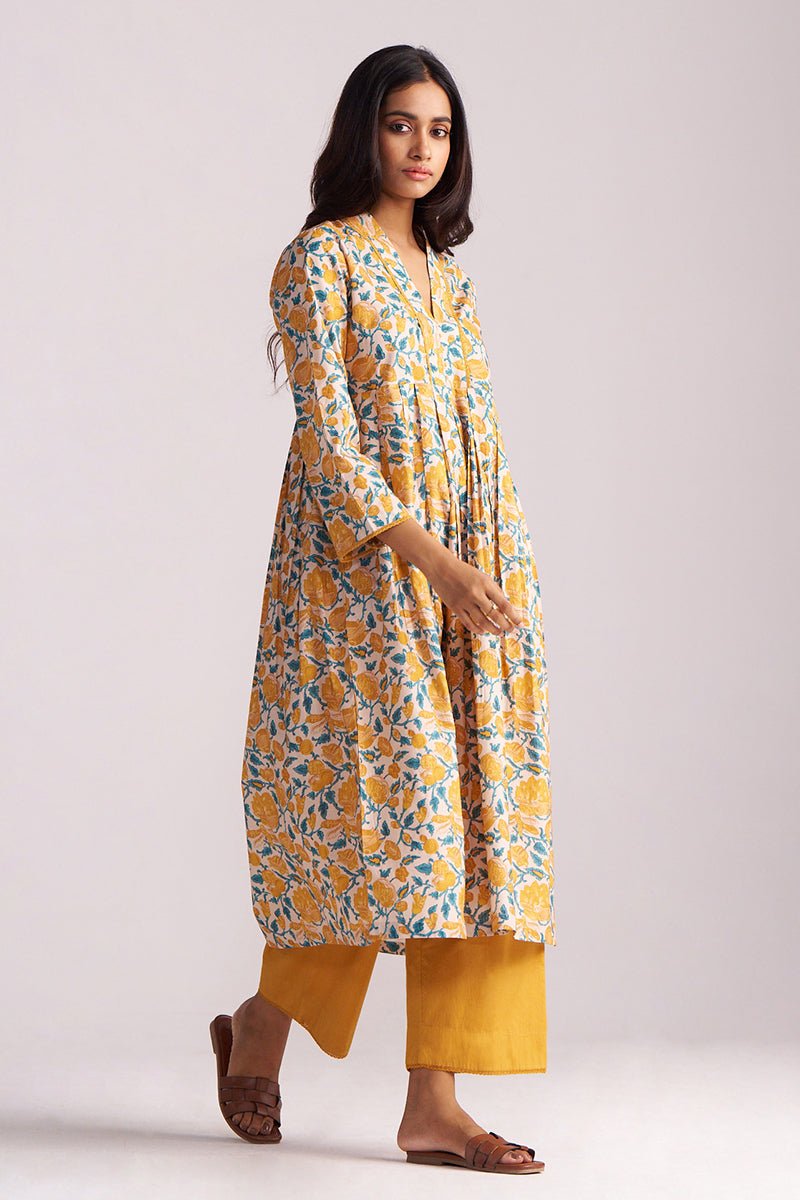Woman wearing a Beige and Mustard Cotton Print Co-ord Set on a white background