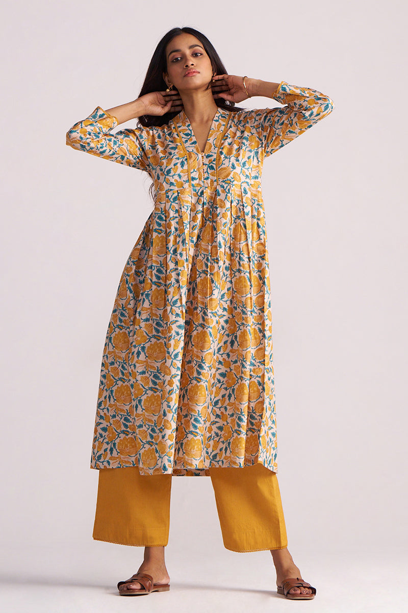 Woman wearing a Beige and Mustard Cotton Print Co-ord Set on a white background