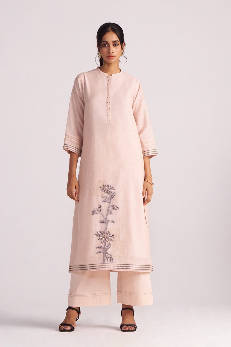 Woman wearing a Sepia Rose Woven Chanderi Kurta Set with floral embroidery on a white background
