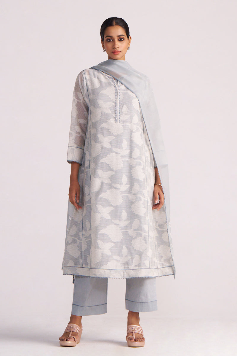 Woman wearing a Grey Woven Pheran Kurta Set on a white background