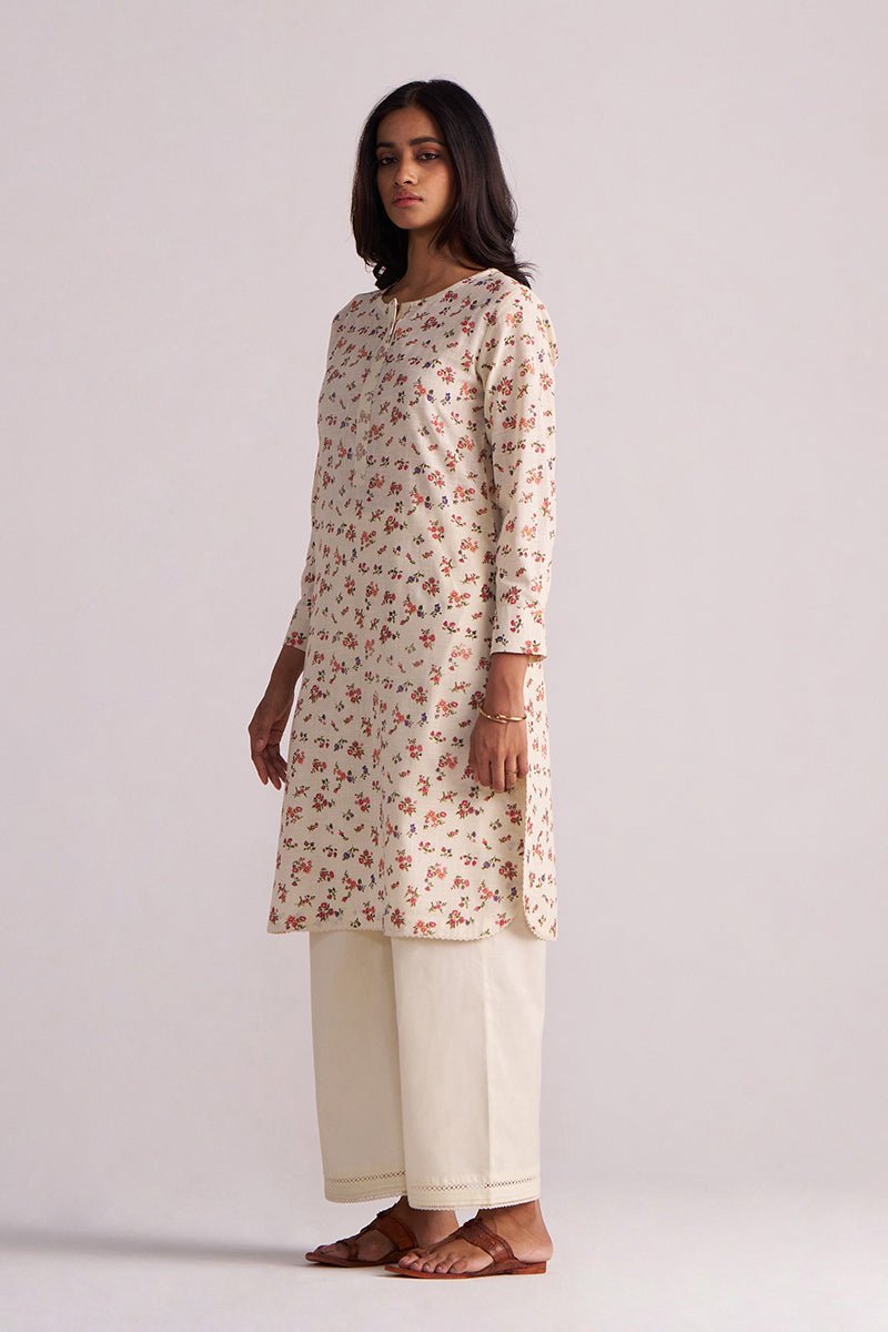 Woman wearing a Cream and Pink Tiny Floral Hand-Print Co-ord Set on a light gray background