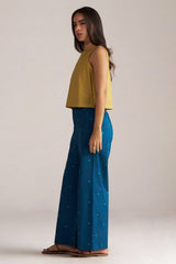 Woman wearing a yellow top and blue pants with a subtle pattern on a plain background | Navigate Blue Checkard Kimono with Moss Yellow Top and Blue Bottom Co Ord Set