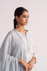 Woman wearing a Grey Woven Pheran Kurta Set outfit with a white background