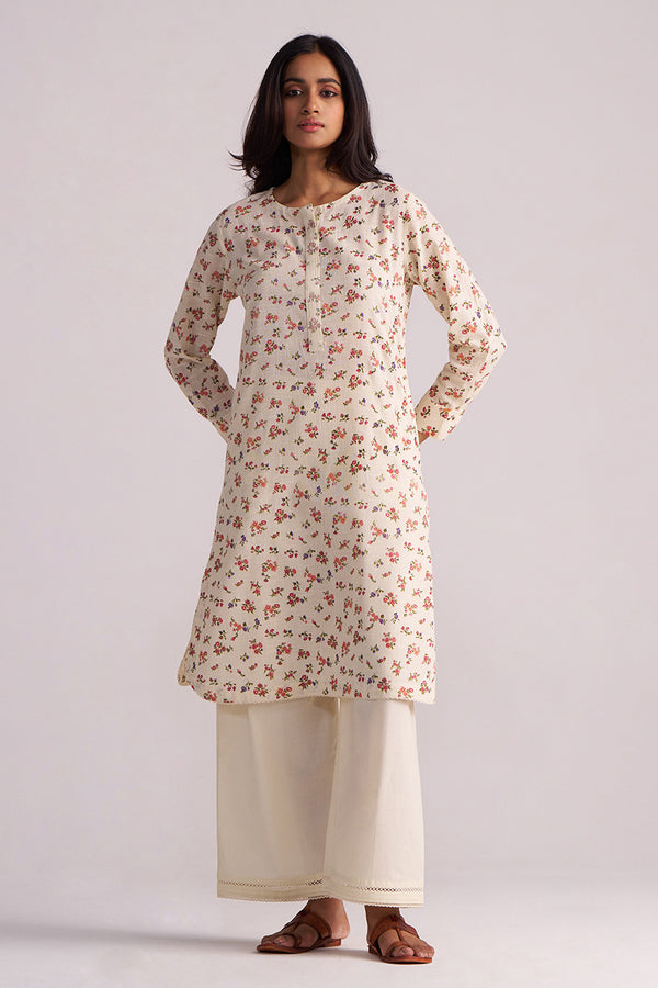Woman wearing a Cream and Pink Tiny Floral Hand-Print Co-ord Set on a light gray background