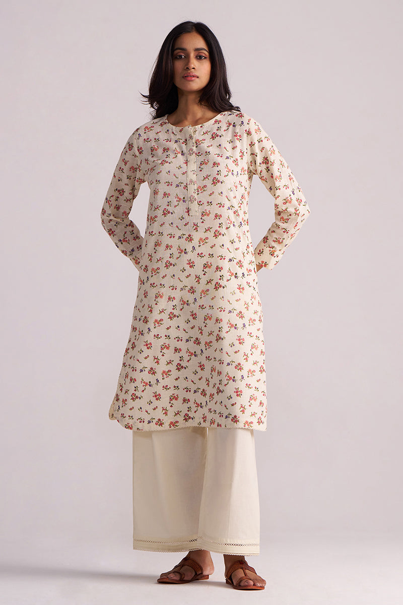 Woman wearing a Cream and Pink Tiny Floral Hand-Print Co-ord Set on a light gray background