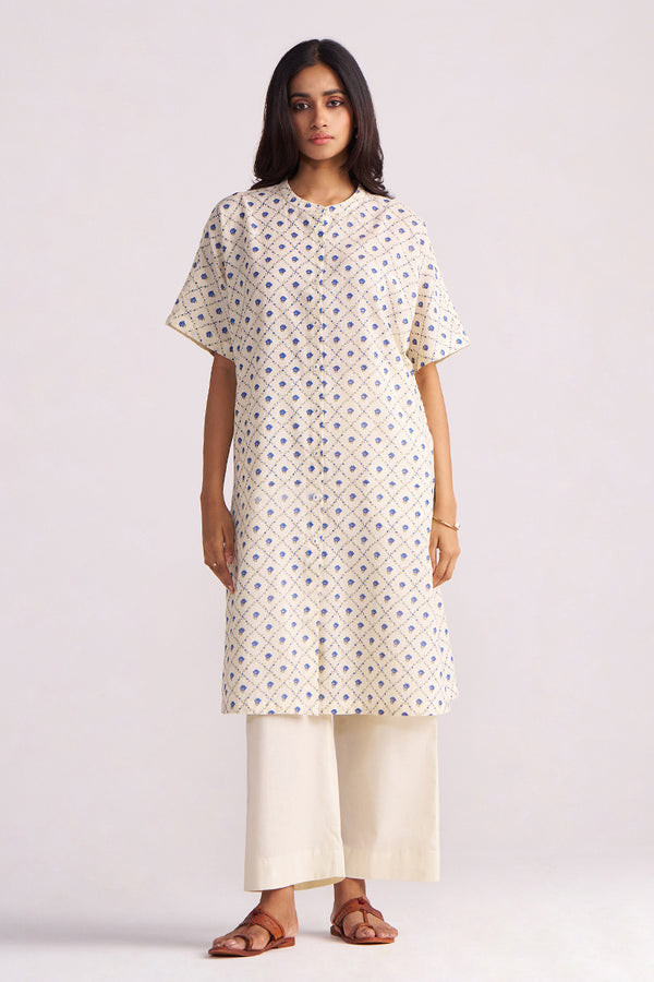 Woman wearing a Cream and Blue Small Flower Hand-Print Cotton Linen Co-ord Set with a plain background