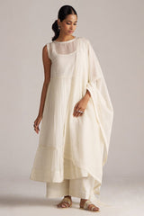 Woman wearing a white dress with a matching shawl against a plain background | Ivory Kota Silk Kurta Set for Women