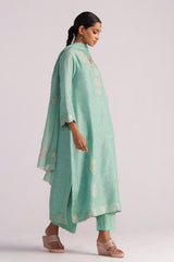 Woman wearing a Dusty Jade Green Woven Silk Kurta Set with a matching dupatta on a plain background