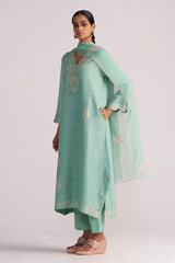 Woman wearing a Dusty Jade Green Woven Silk Kurta Set on a white background