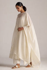 Woman wearing a cream-colored traditional outfit with a plain background | Ivory Kota Silk Kurta Set for Women