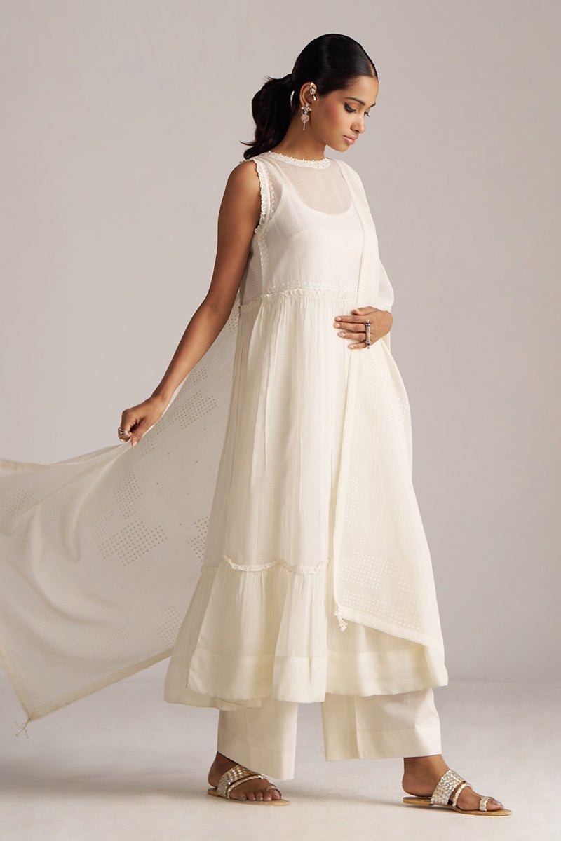 Woman wearing a white dress with a plain background | Ivory Kota Silk Kurta Set for Women