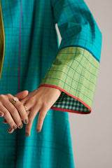 Teal and green checkered garment with a hand holding it against a neutral background | Navigate Blue Checkard Kimono with Moss Yellow Top and Blue Bottom Co Ord Set