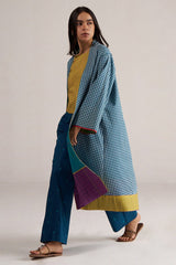 Woman wearing a blue and green checkered outfit with a yellow top on a plain background | Navigate Blue Checkard Kimono with Moss Yellow Top and Blue Bottom Co Ord Set