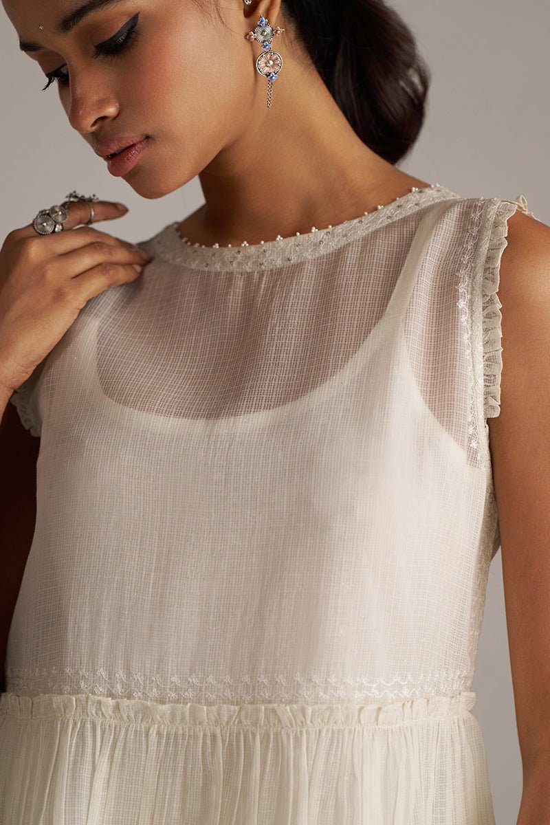 Woman wearing a light-colored dress with sheer neckline against a neutral background | Ivory Kota Silk Kurta Set for Women