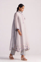Woman wearing a Grey Woven Kurta Set with floral patterns on a white background