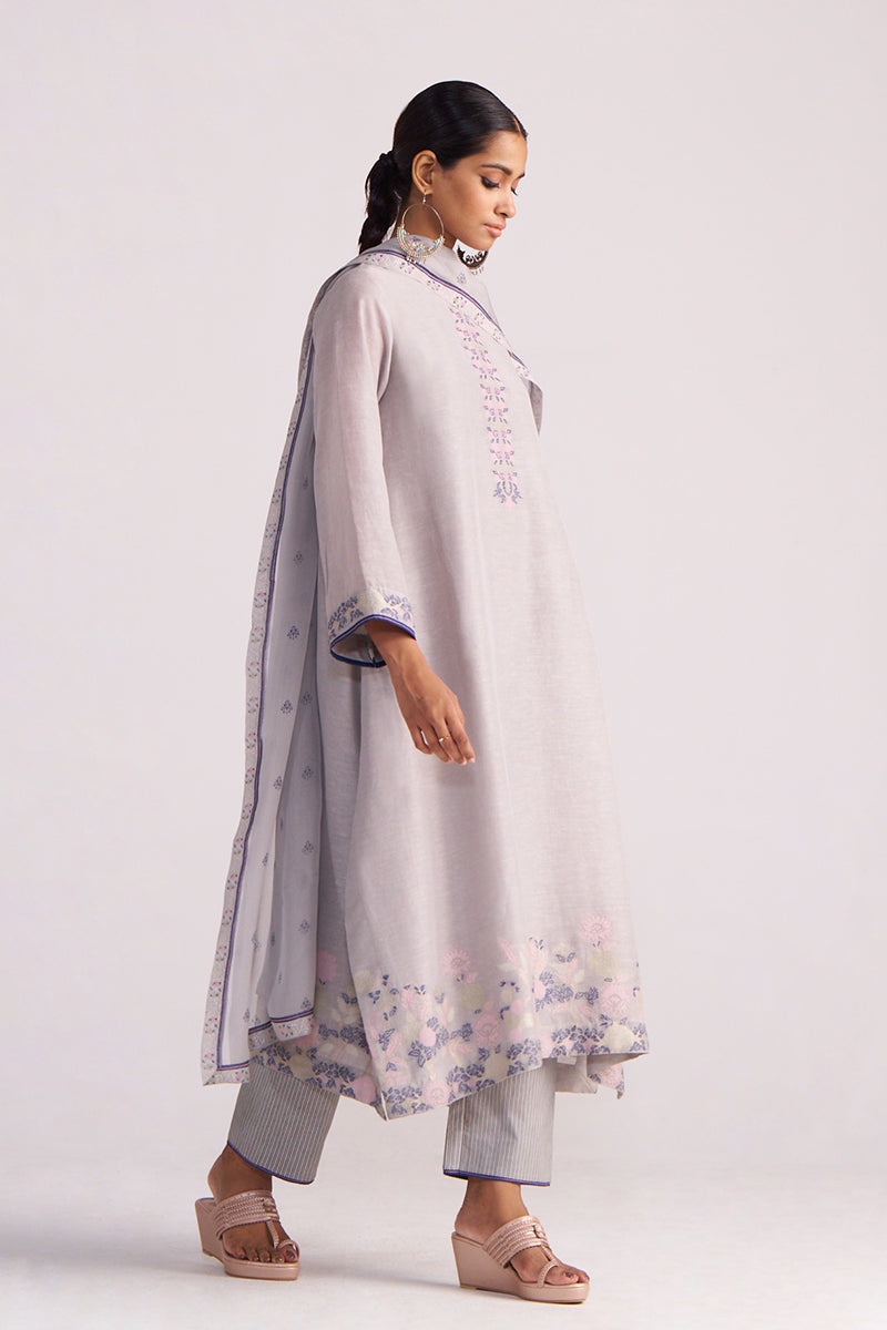 Woman wearing a Grey Woven Kurta Set with floral patterns on a white background