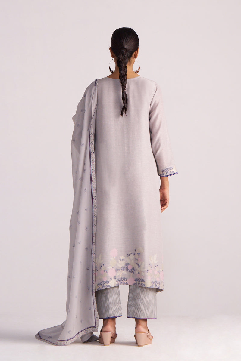 Woman wearing a Grey Woven Kurta Set with a long scarf on a white background
