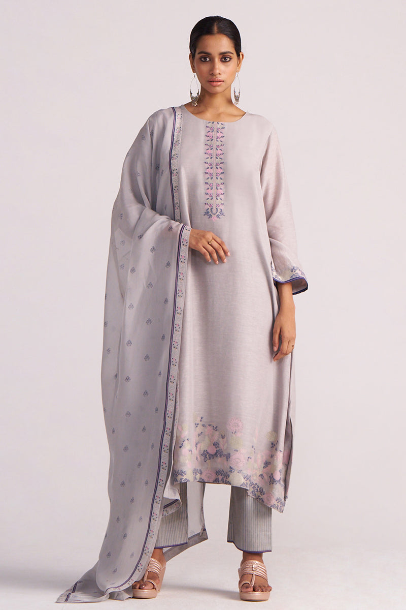 Woman wearing a Grey Woven Kurta Set and matching dupatta on a white background