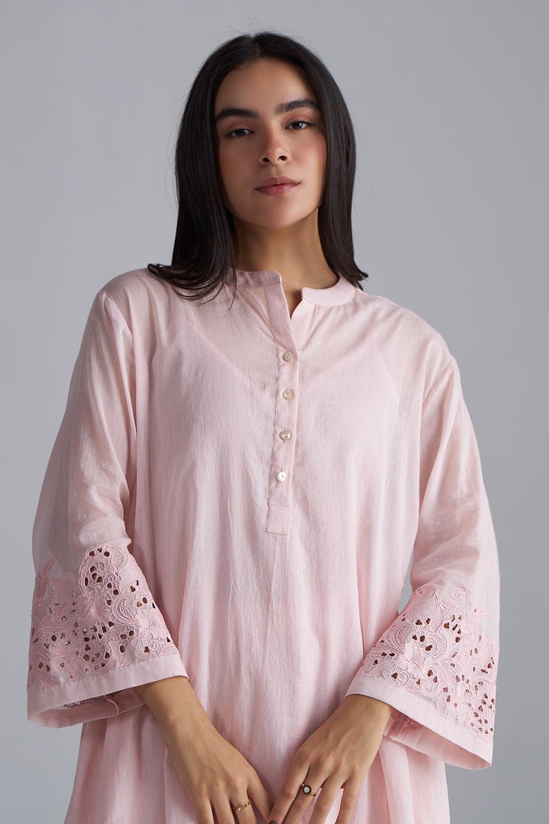 Woman wearing a light pink kurta with intricate detailing on a gray , Crystal Pink Mul Mul Co-ord Set for Women | Ganga Fashionsbackground