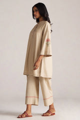 Woman wearing a beige outfit with floral embroidery on a plain background | Brown Rice Co-ord Set – Solid Ethnic Wear | Ganga Fashions