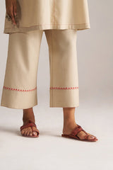 Beige pants with red embroidery and sandals on a plain background | Brown Rice Co-ord Set – Solid Ethnic Wear | Ganga Fashions