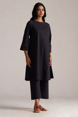 Woman wearing a black dress with a plain background | Black Co-ord Set – Ethnic Wear for Women | Ganga Fashions