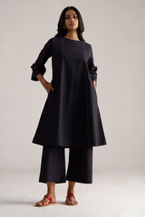 Woman wearing a black dress with cropped pants on a plain background | Black Co-ord Set – Ethnic Wear for Women | Ganga Fashions