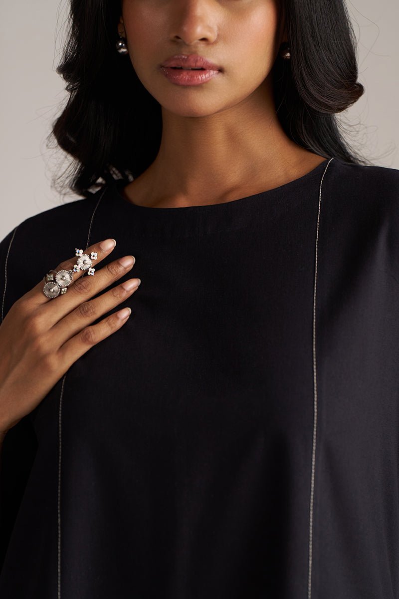 Woman wearing a black top with a necklace and ring, against a neutral background | Black Co-ord Set – Ethnic Wear for Women | Ganga Fashions