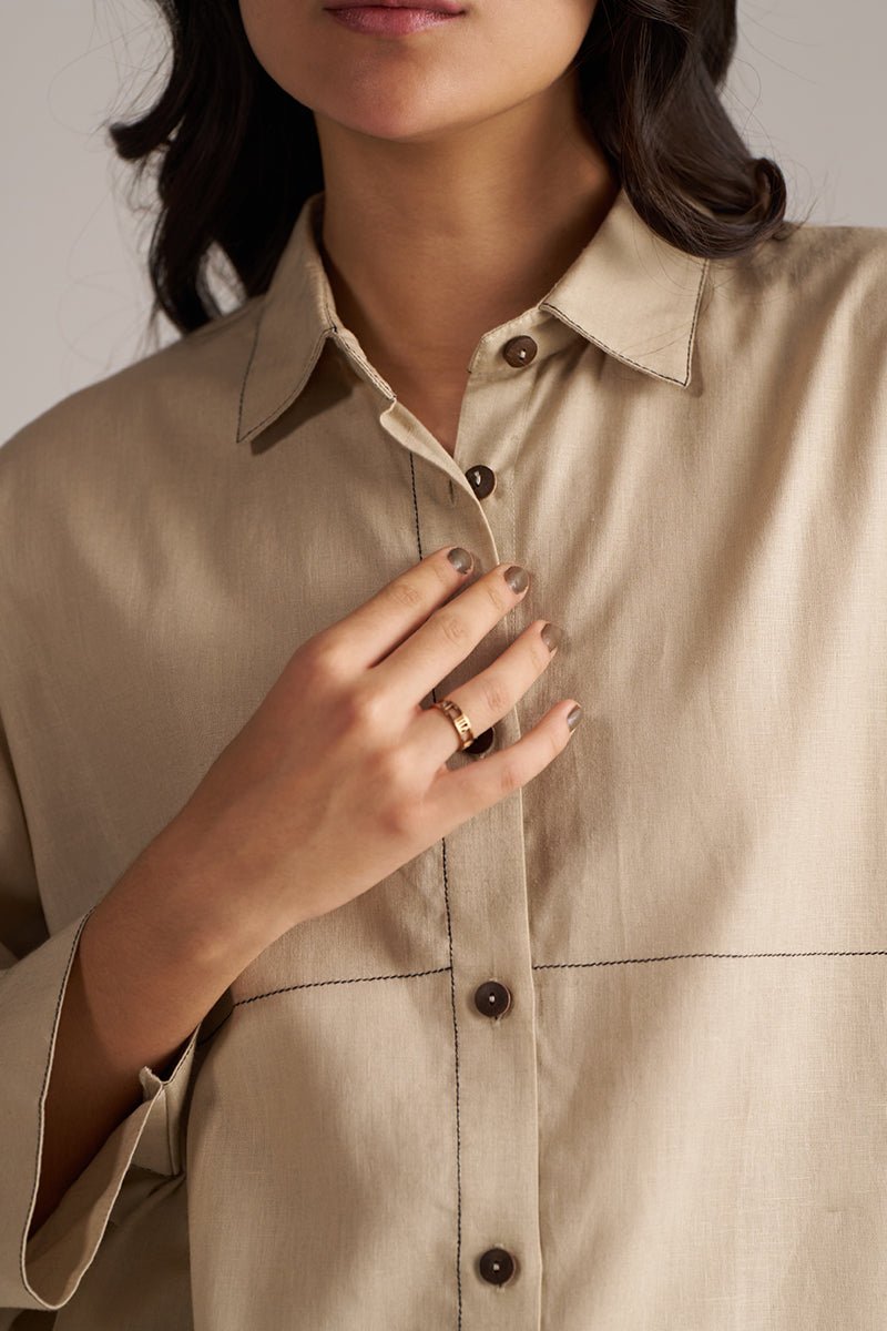 Close-up of a person wearing a beige button-up shirt with a neutral background | Brown Rice Co-ord Set for Women | Rangmanch | Ganga Fashions