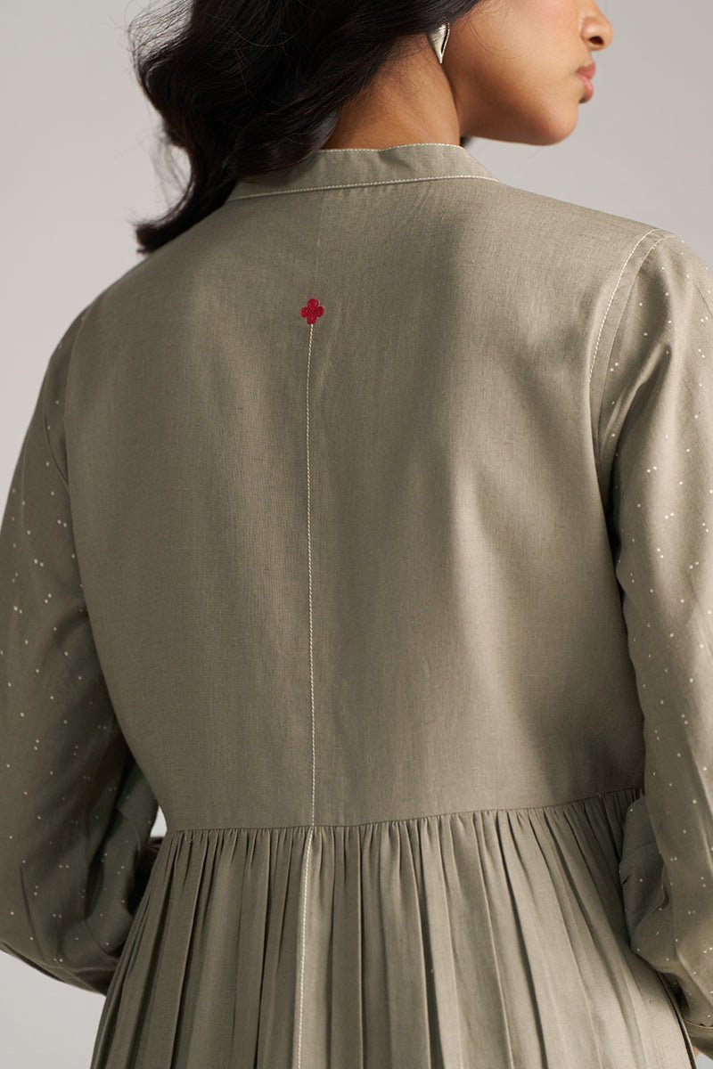 Person wearing a light green dress with a red flower detail on the back against a neutral background | Buy Grey Co-ord Set for Women | Rangmanch Collection - Ganga Fashions