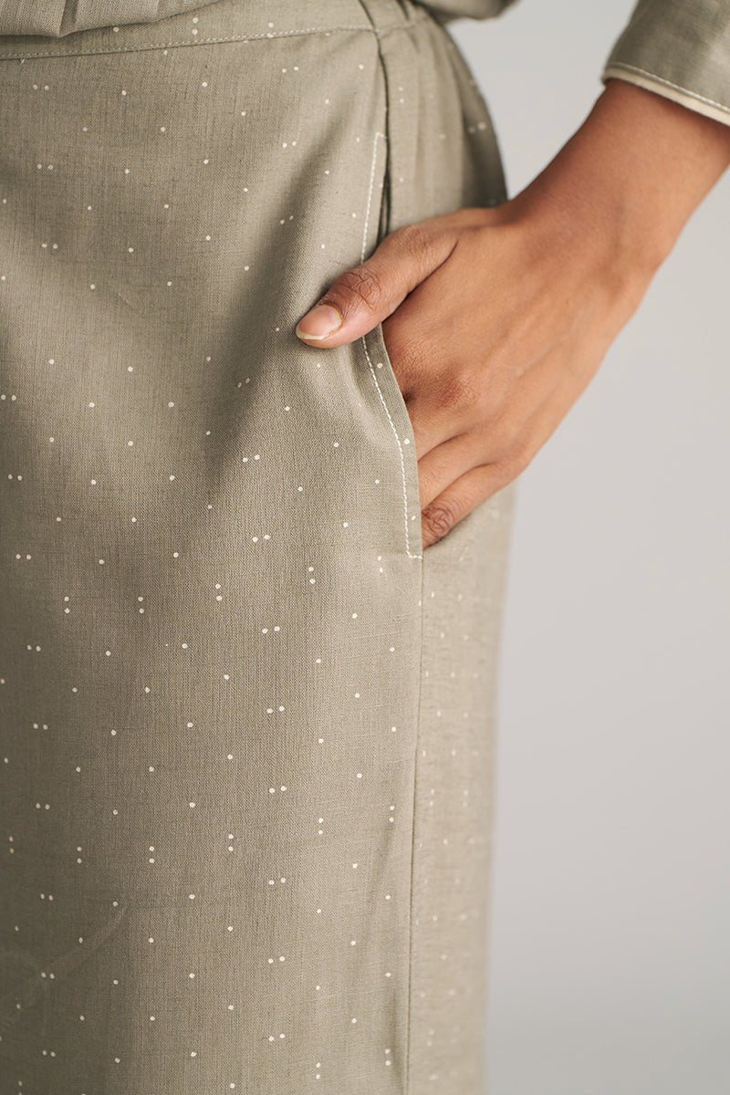 Close-up of a person wearing a green dress with white polka dots, holding their hand in a pocket. | Buy Grey Co-ord Set for Women | Rangmanch Collection - Ganga Fashions