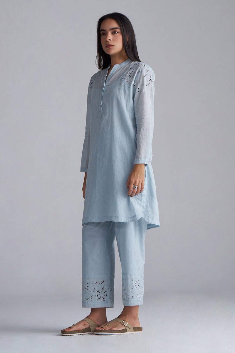 Woman wearing a light blue embroidered outfit on a plain background | Chalk Blue Mul Mul Co-ord Set for Women | Ganga Fashions