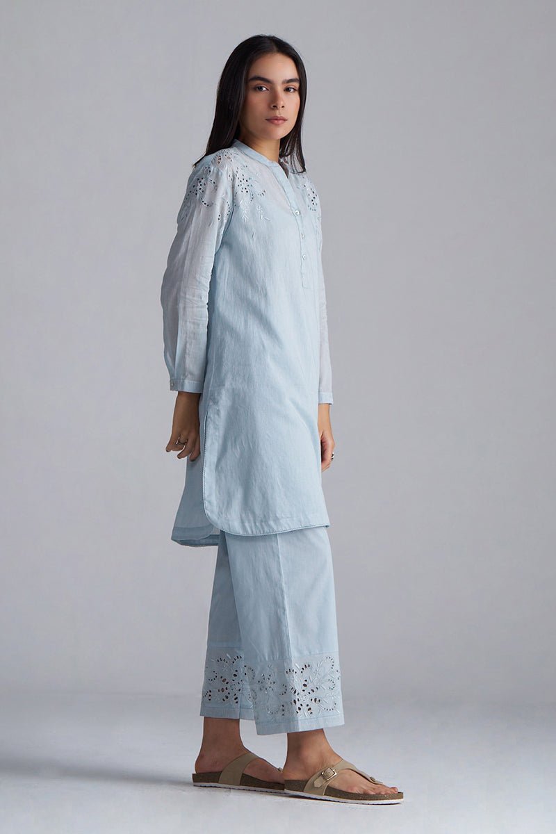 Woman wearing a light blue embroidered outfit on a plain background |Chalk Blue Mul Mul Co-ord Set for Women | Ganga Fashions