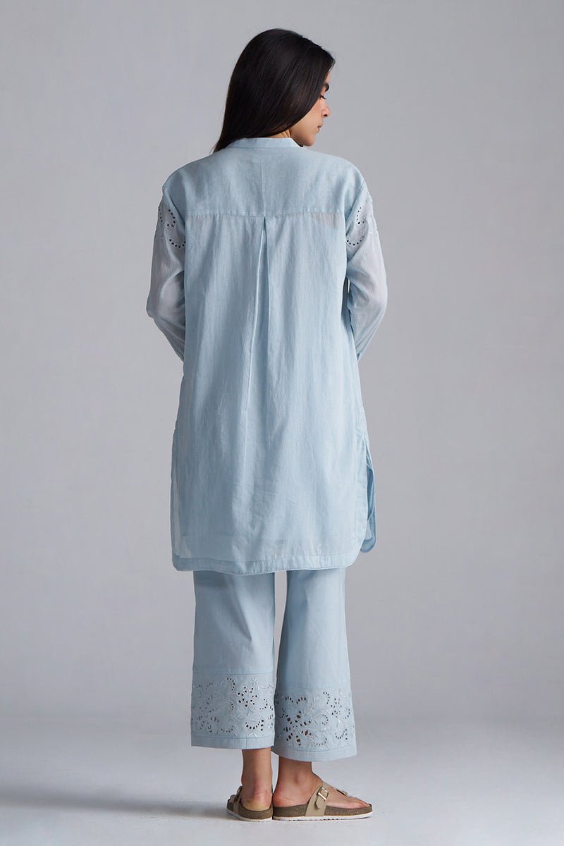 Woman wearing a light blue embroidered outfit on a plain background | Chalk Blue Mul Mul Co-ord Set for Women | Ganga Fashions