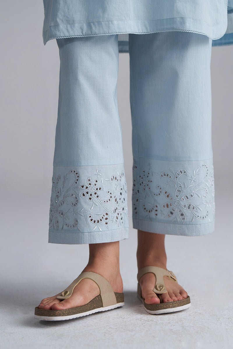 Light blue pants with lace detailing worn by a person, standing on a light gray background. |Chalk Blue Mul Mul Co-ord Set for Women | Ganga Fashions