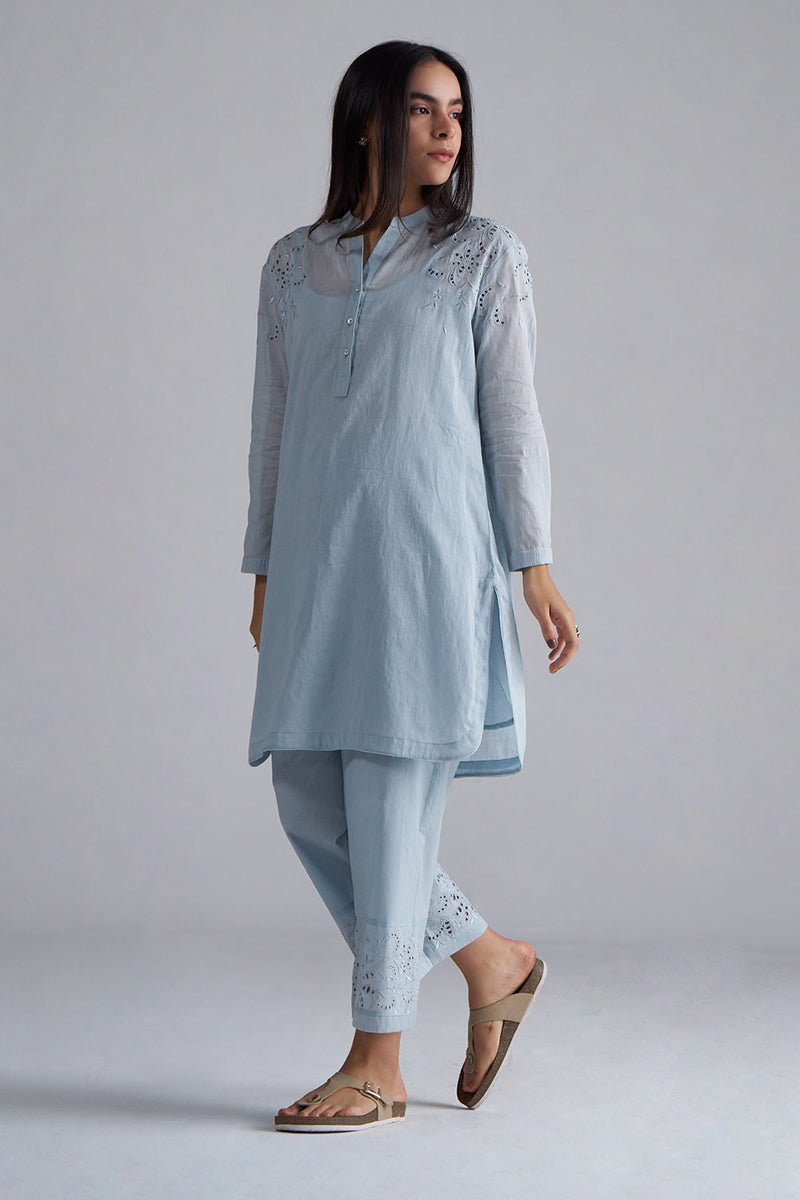 Woman wearing a light blue embroidered outfit on a plain background | Chalk Blue Mul Mul Co-ord Set for Women | Ganga Fashions