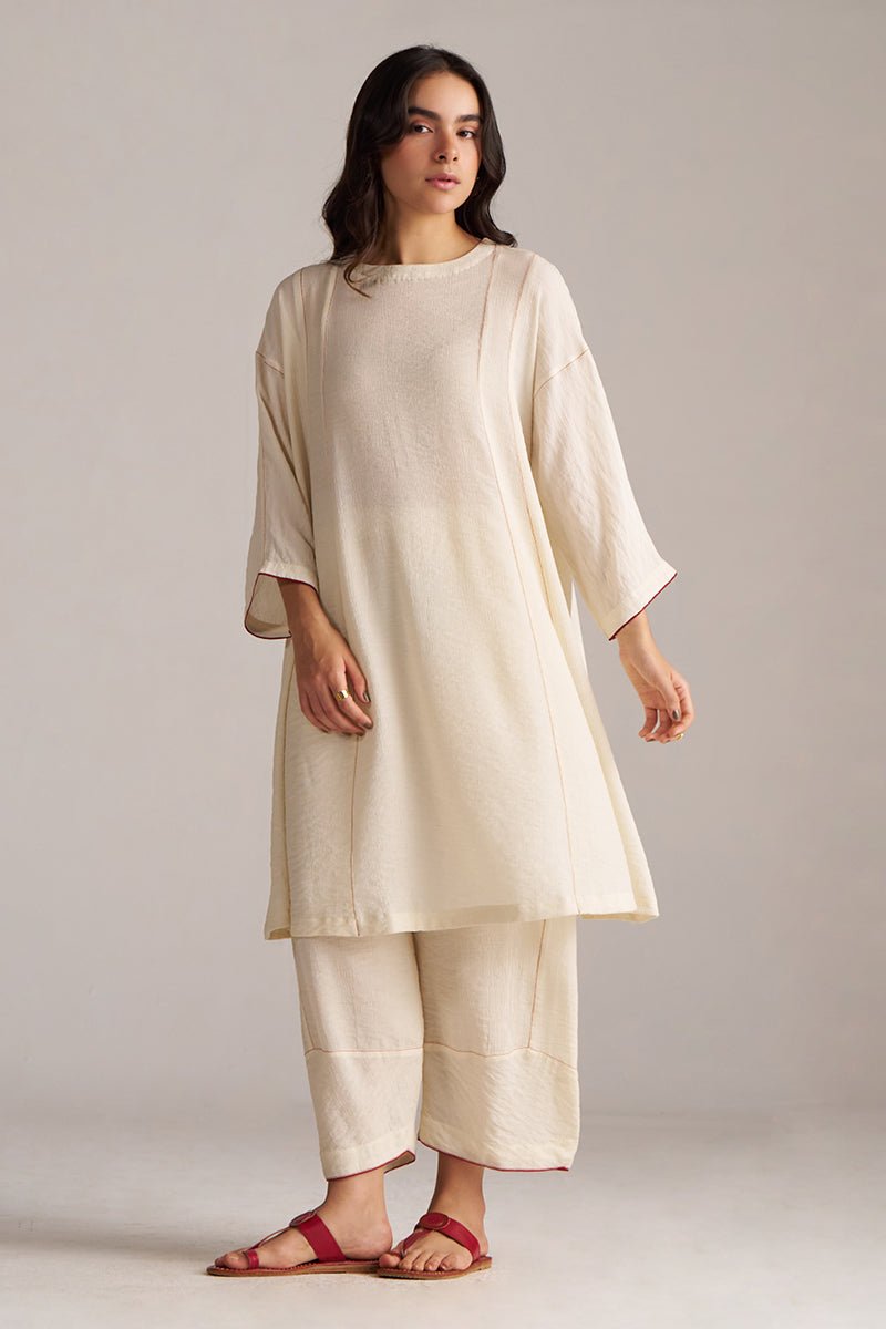 Woman wearing a beige kurta with pants against a plain background, Birch Cream Co-ord Set for Women | Rangmanch | Ganga Fashions