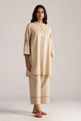Woman wearing a beige traditional outfit with a plain background | Brown Rice Co-ord Set – Solid Ethnic Wear | Ganga Fashions