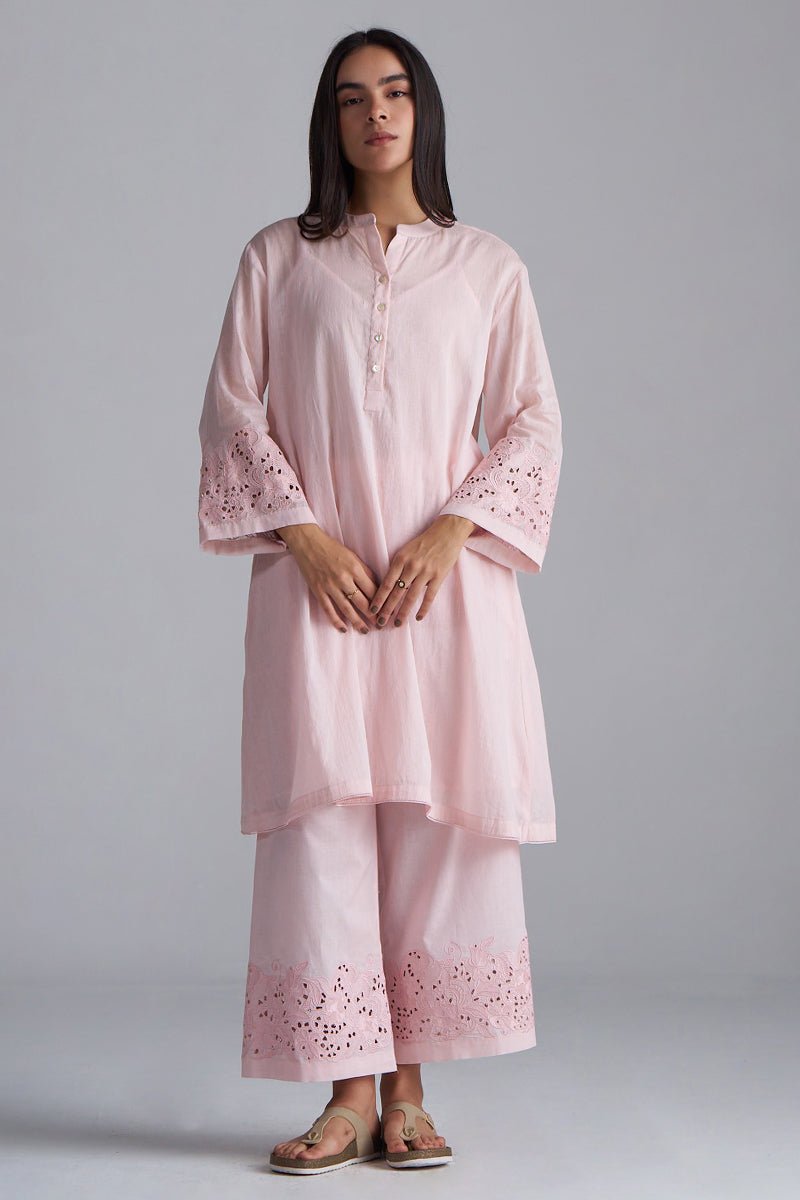 Woman wearing a light pink traditional outfit with embroidery on a gray background, Crystal Pink Mul Mul Co-ord Set for Women | Ganga Fashions