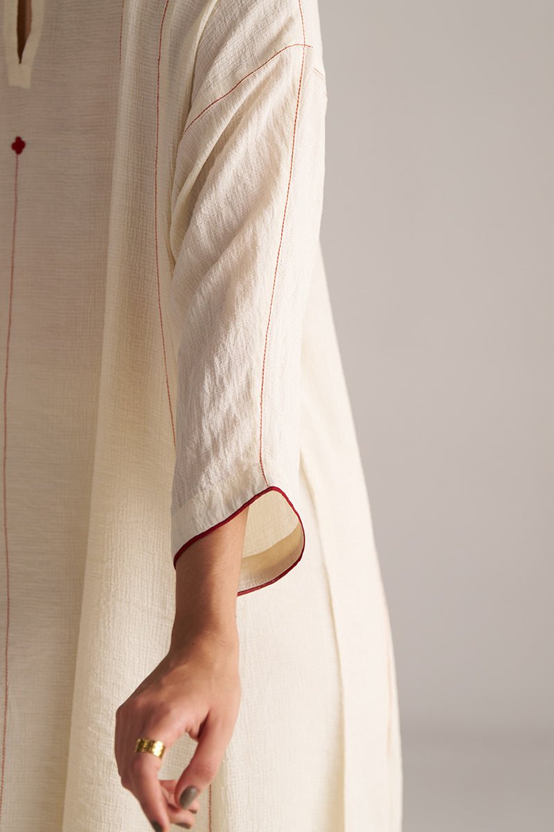 Close-up of a person wearing a light-colored outfit with red accents on a plain background, Birch Cream Co-ord Set for Women | Rangmanch | Ganga Fashions