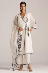 Woman wearing a white outfit with floral patterns on a plain background | Ivory Navy Angrakha Chanderi Kurta Set