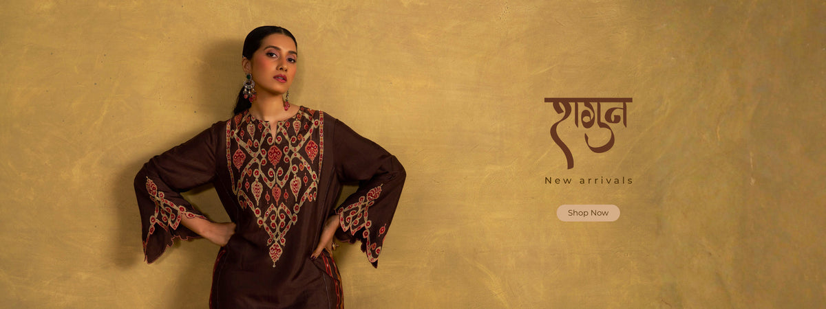 A woman modeling a dark brown embroidered kurta against a textured gold background, with Hindi text and a 'Shop Now' button on the right side. | Ganga Fashions Shagun Collections